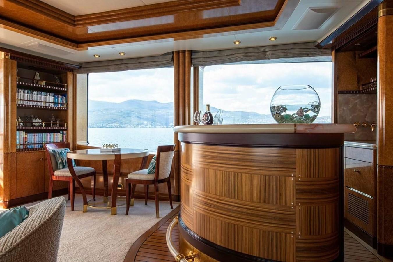 a room with a table chairs and a window aboard LADY MAJA I Yacht for Sale