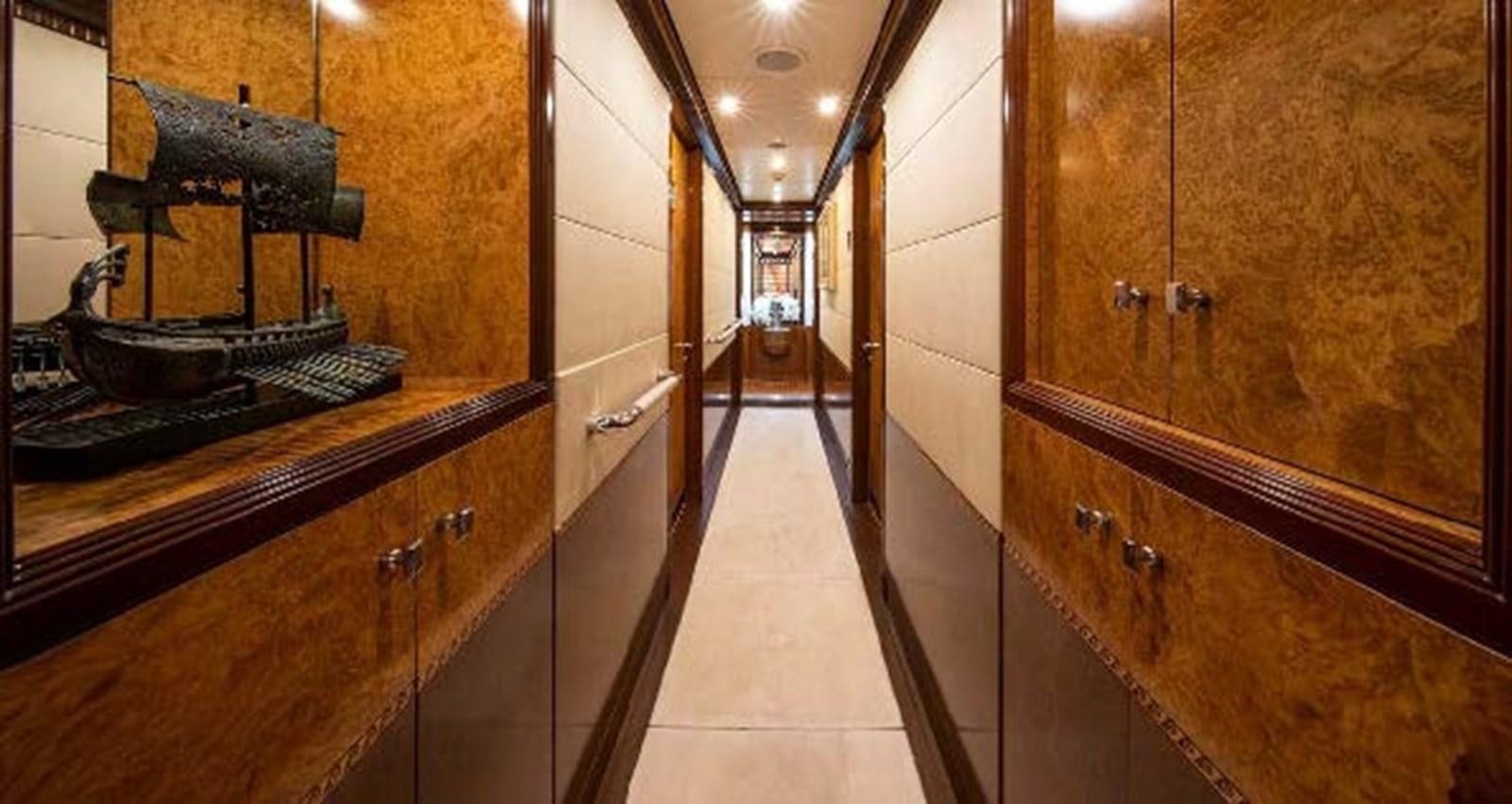 a hallway with wood cabinets aboard LADY MAJA I Yacht for Sale
