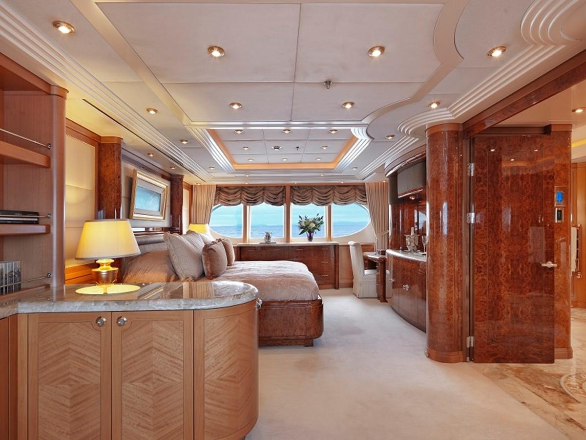 a living room with a large wood cabinet and a large window aboard CAPRI I Yacht for Sale