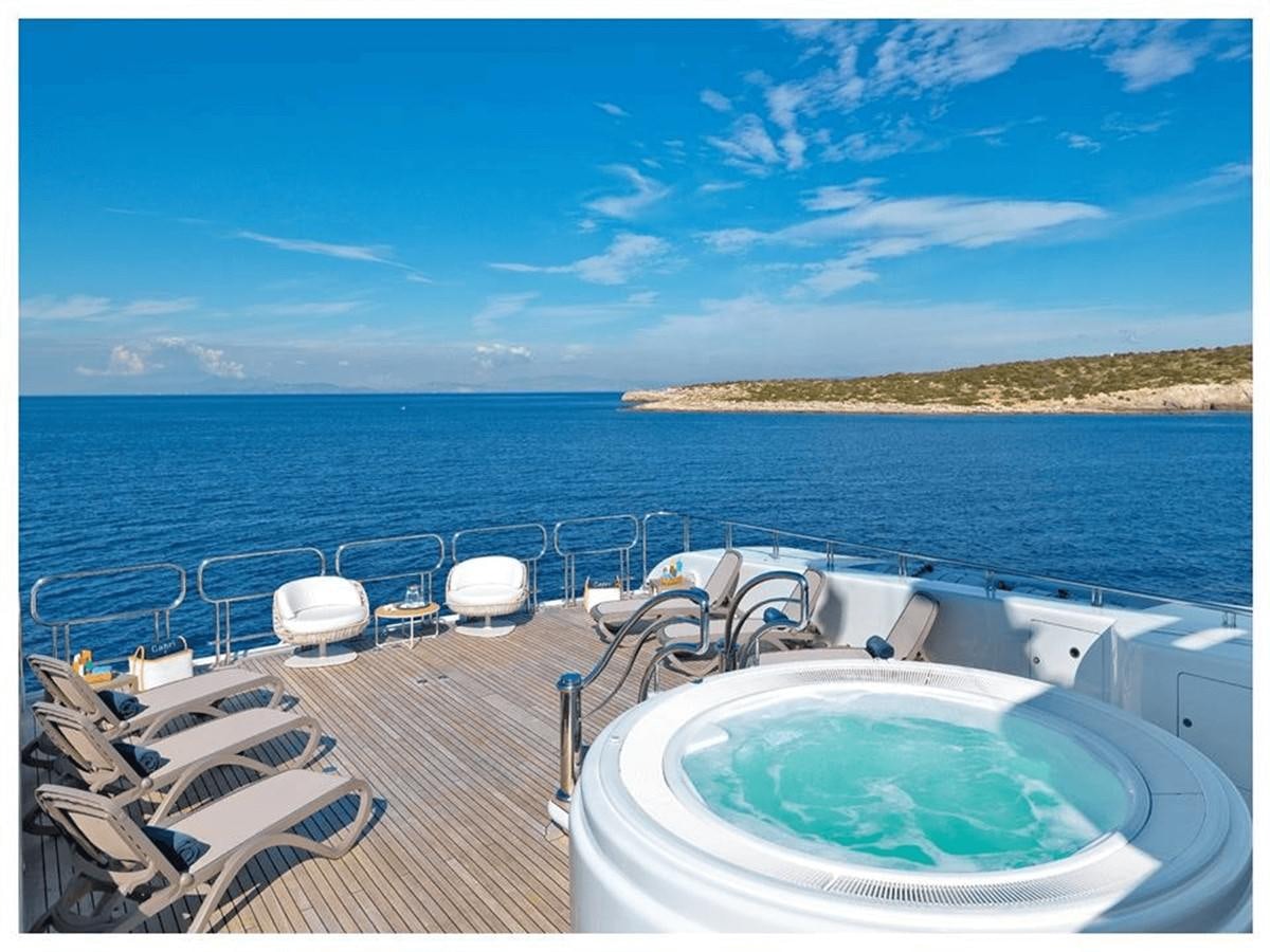 a deck with chairs and a pool aboard CAPRI I Yacht for Sale