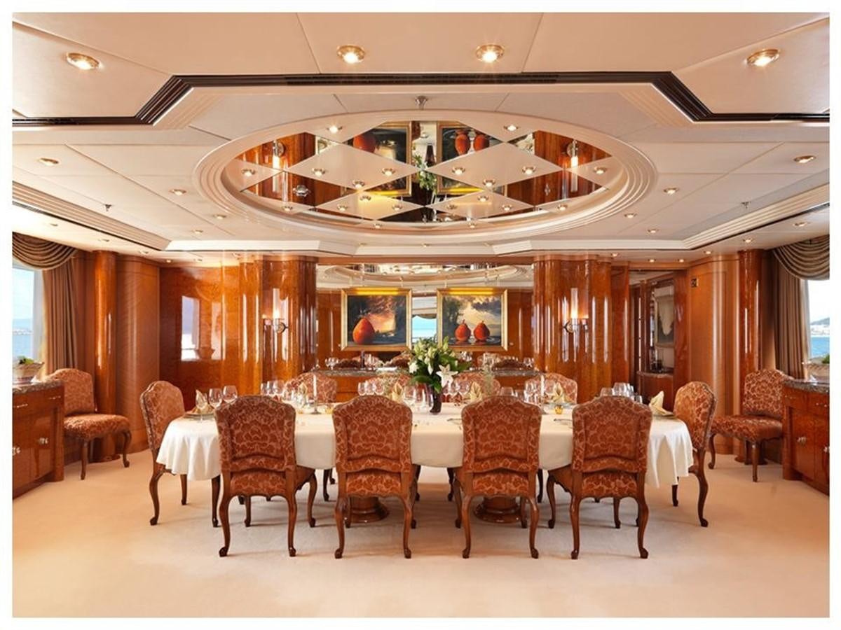 a large room with a table and chairs aboard CAPRI I Yacht for Sale