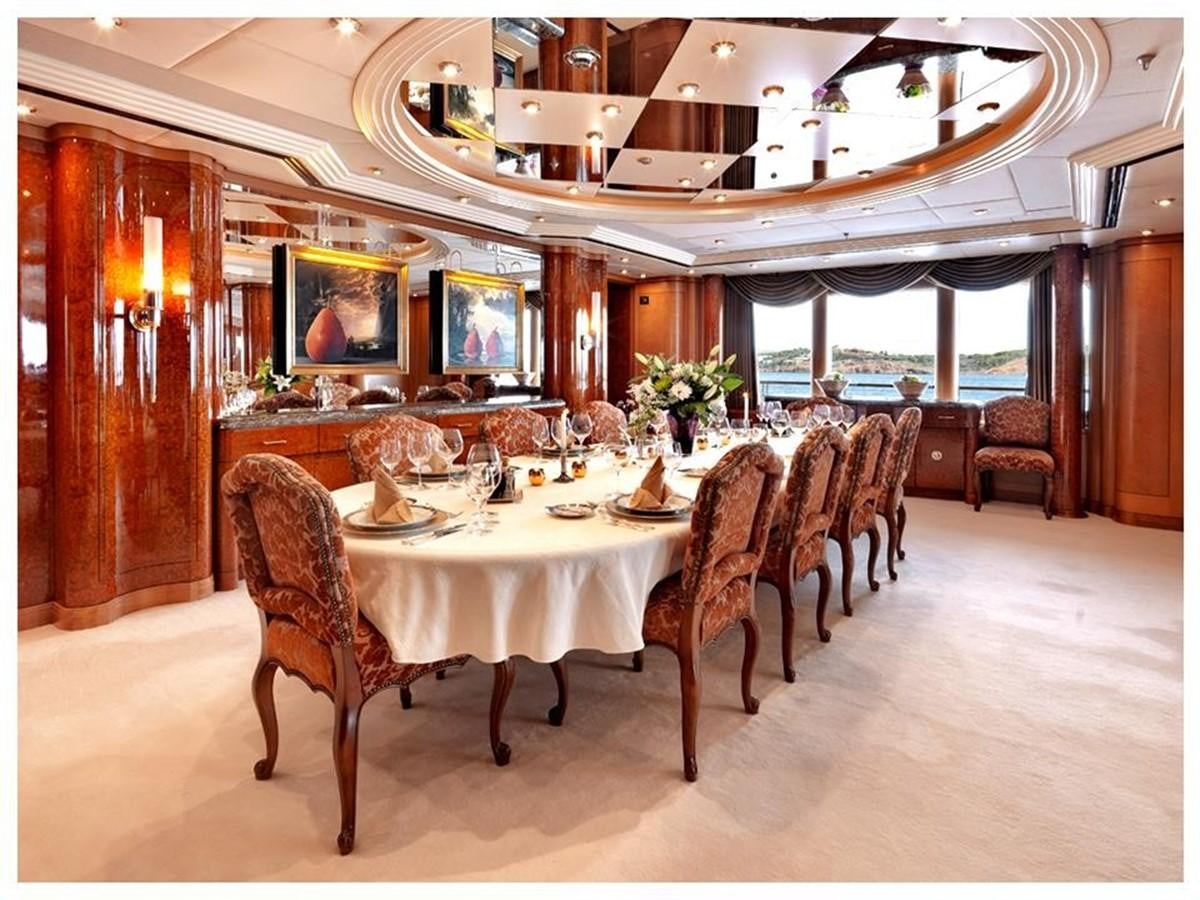 a dining room with a table aboard CAPRI I Yacht for Sale