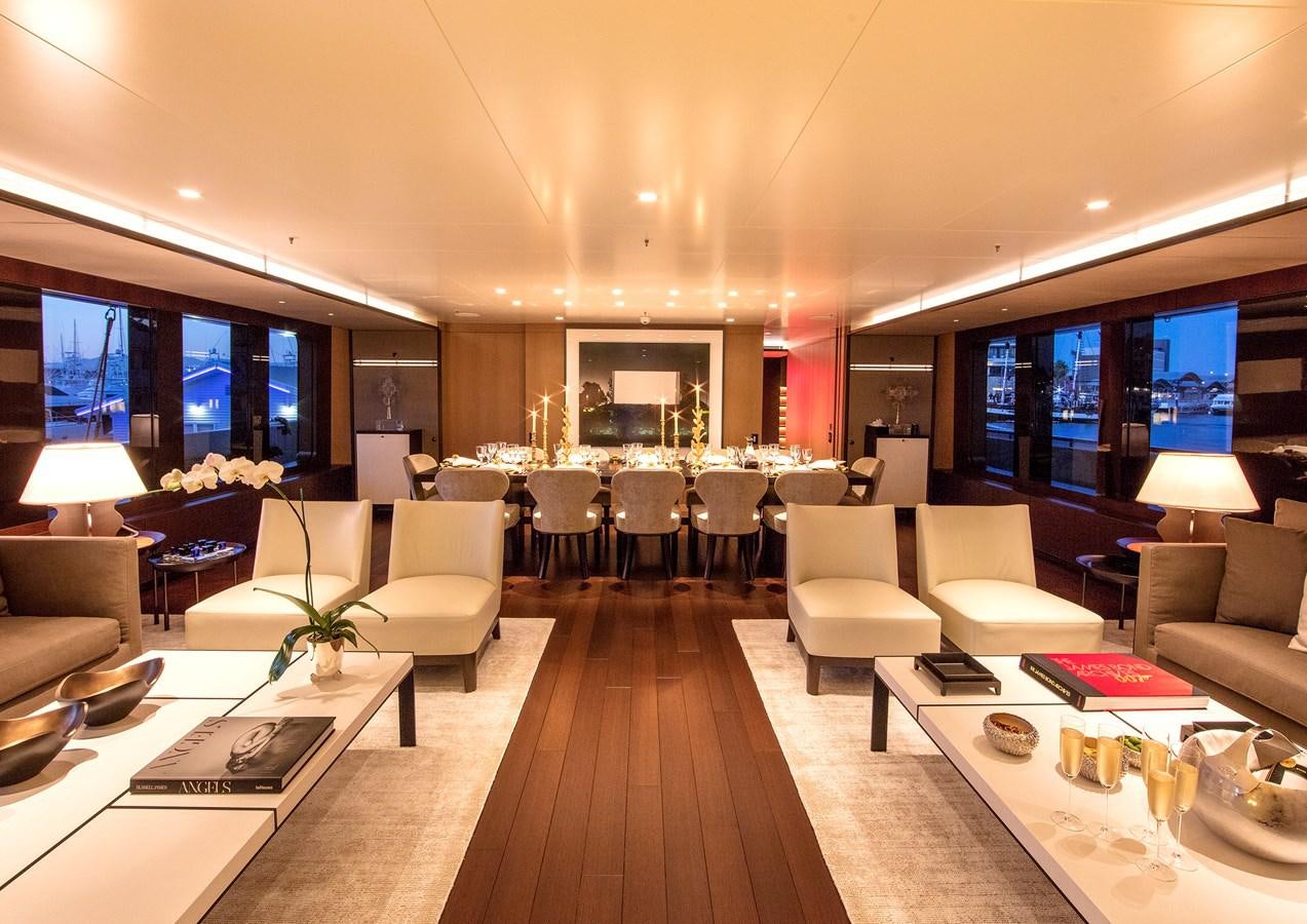 a large room with a table and chairs aboard HALO Yacht for Sale