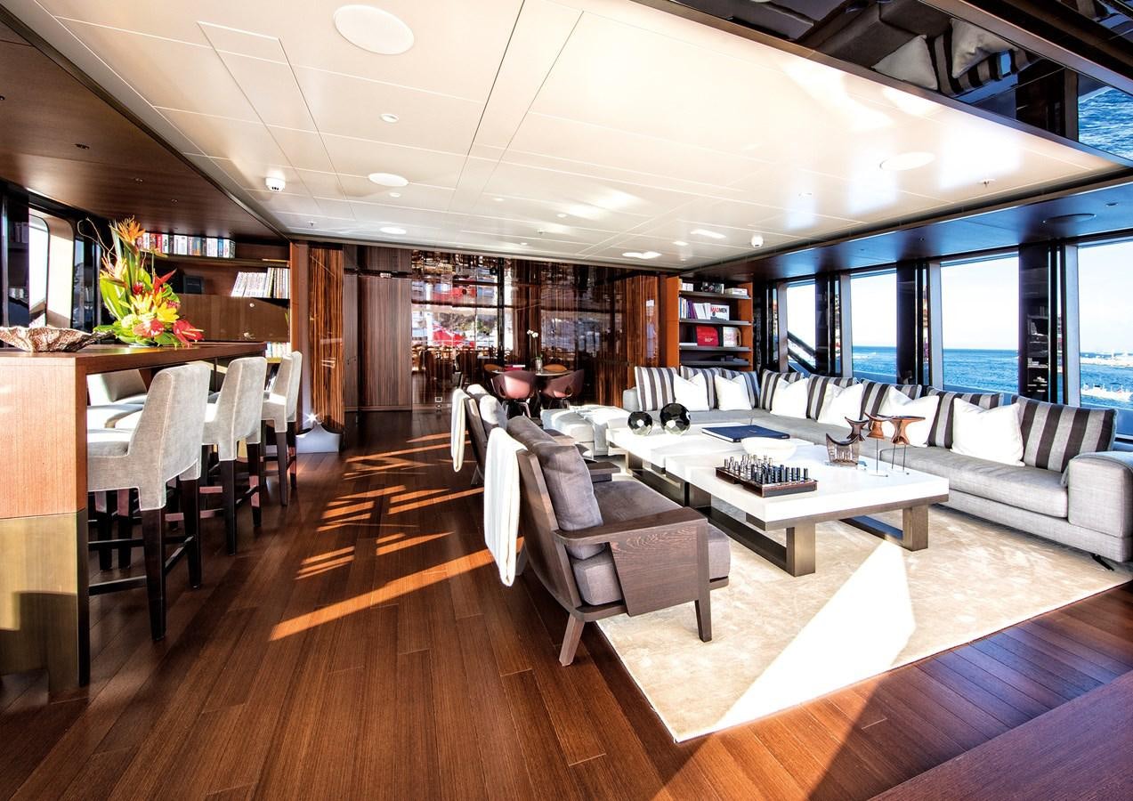 a room with a couch and a table and chairs aboard HALO Yacht for Sale
