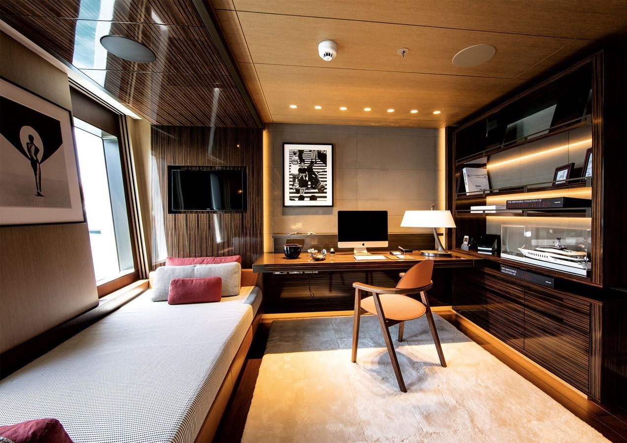 a room with a bed and a desk aboard HALO Yacht for Sale