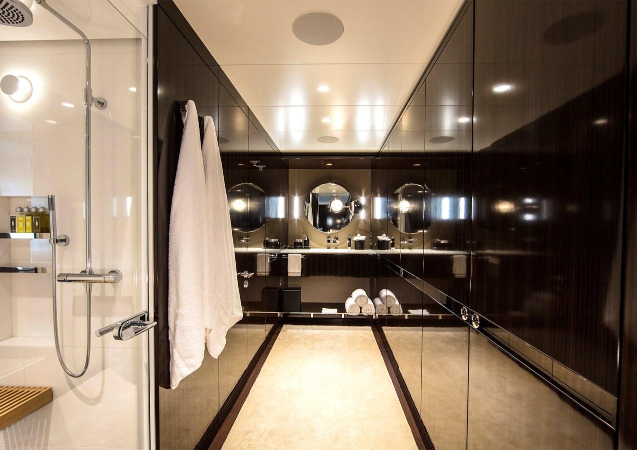 a large bathroom with a glass shower aboard HALO Yacht for Sale