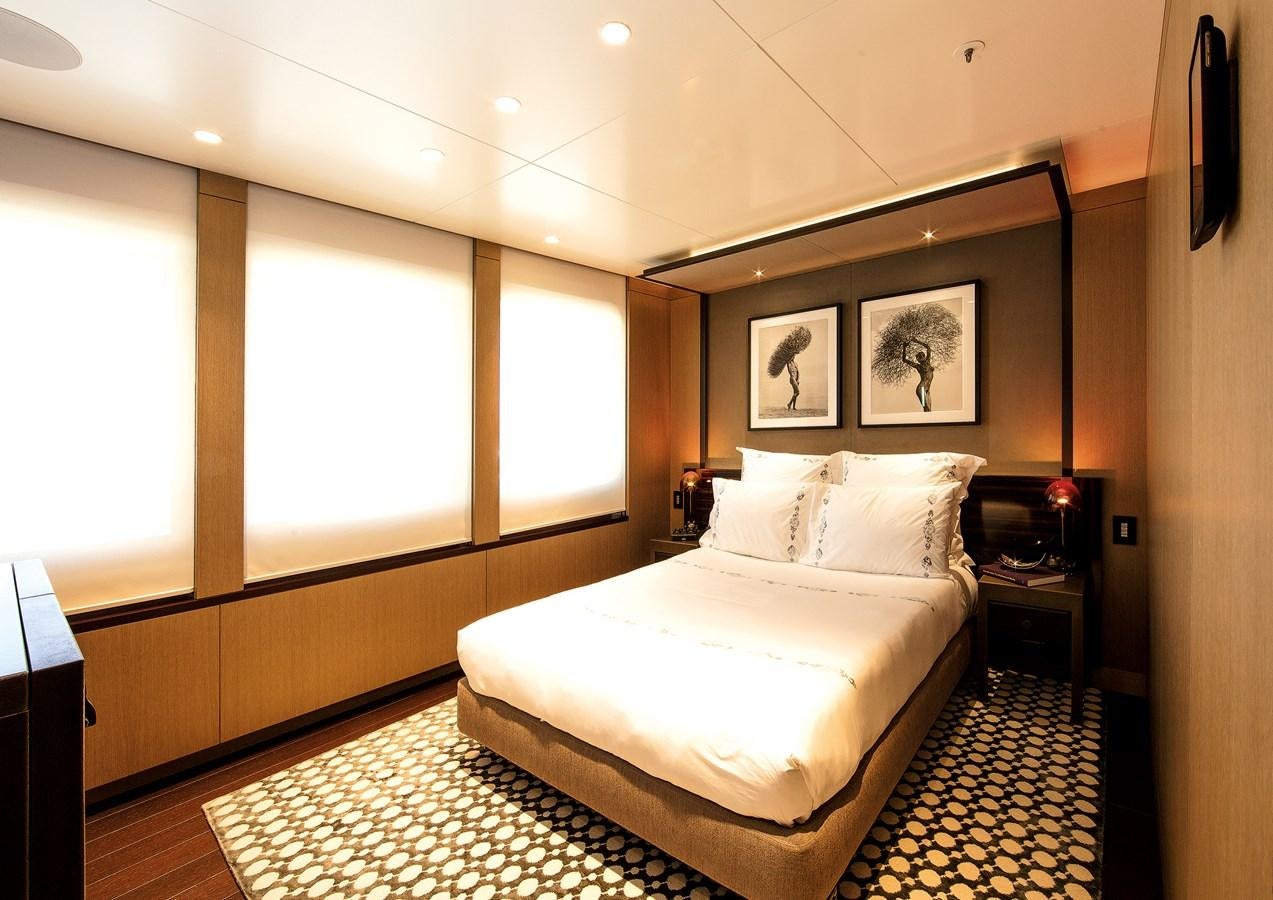 a bedroom with a large bed aboard HALO Yacht for Sale