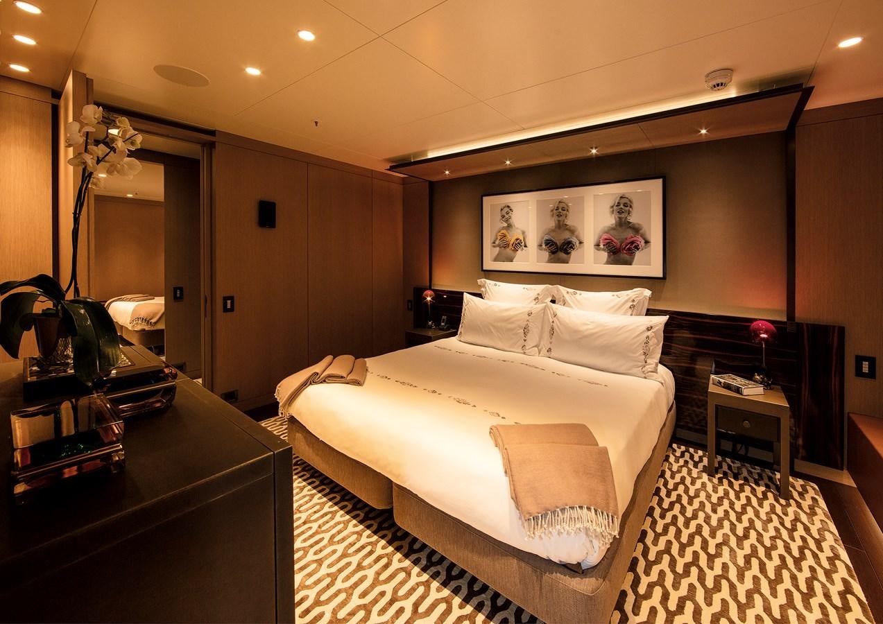 a bedroom with a large bed aboard HALO Yacht for Sale