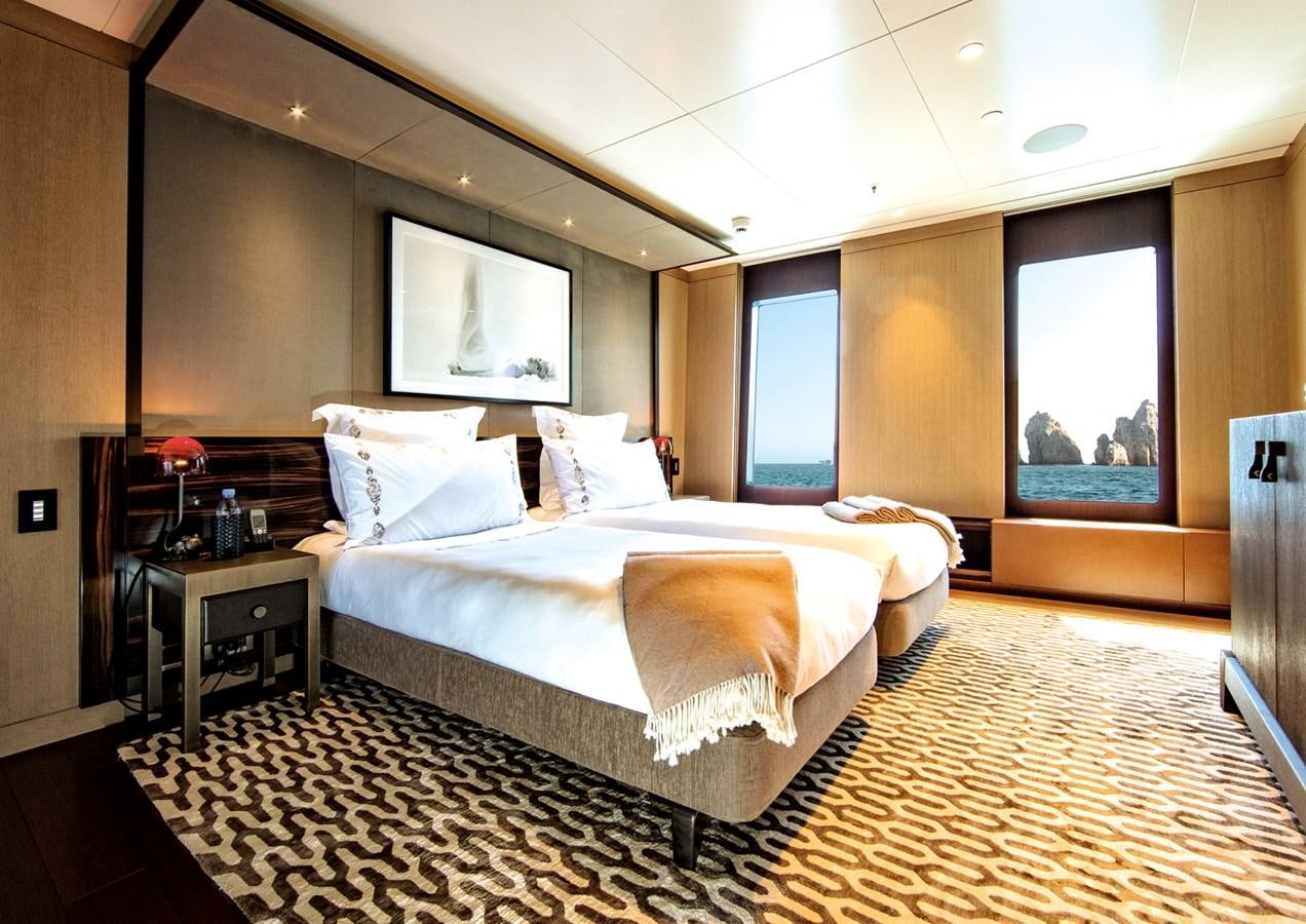 a large bedroom with a large bed aboard HALO Yacht for Sale