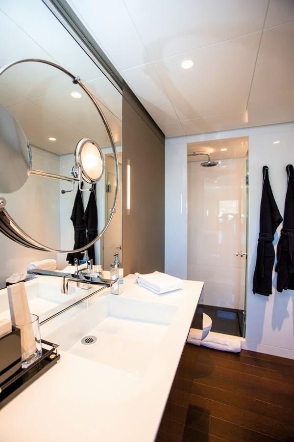 a bathroom with a large mirror aboard HALO Yacht for Sale