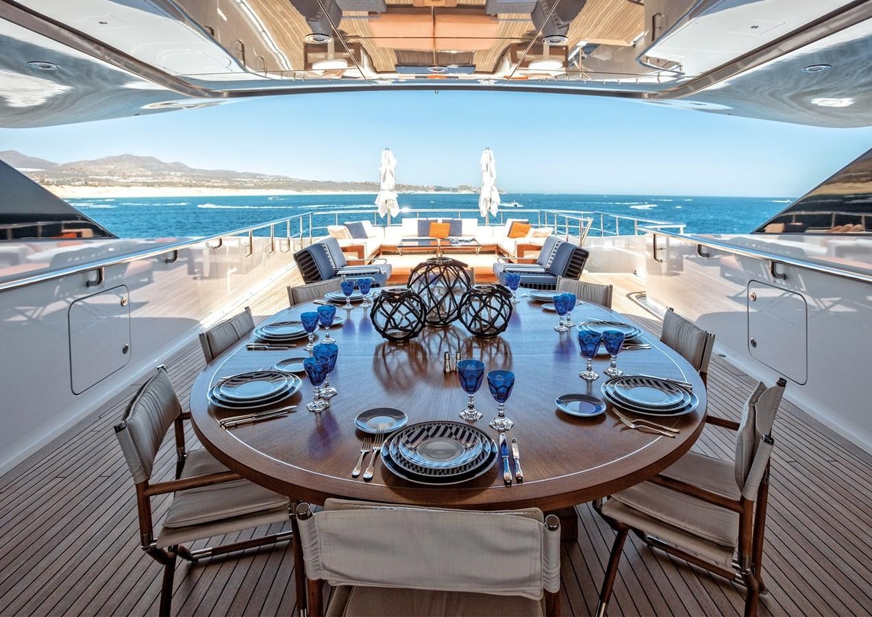 a dining room with a large table and chairs aboard HALO Yacht for Sale