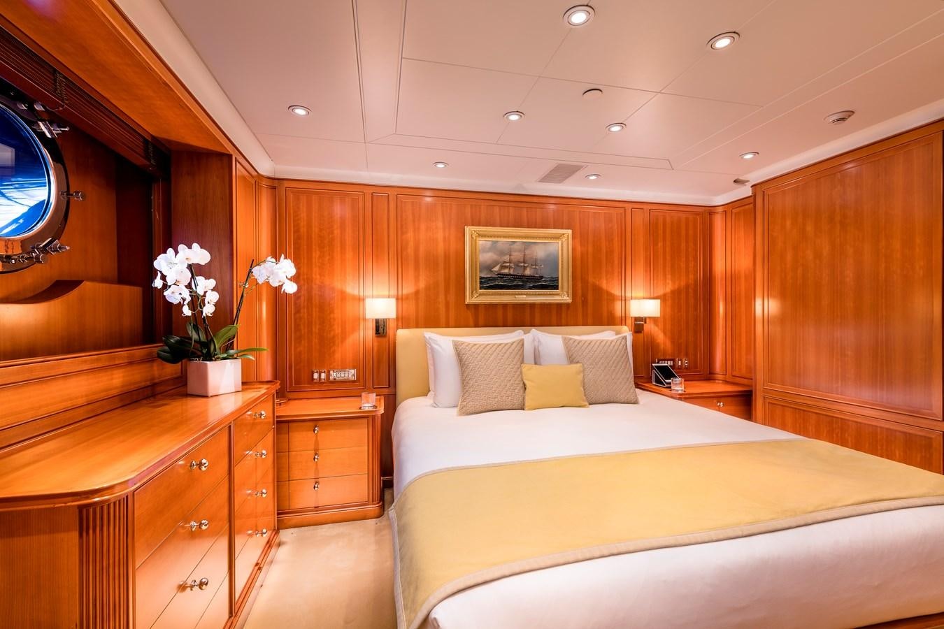a hotel room with a bed and a mirror aboard ZENJI Yacht for Sale