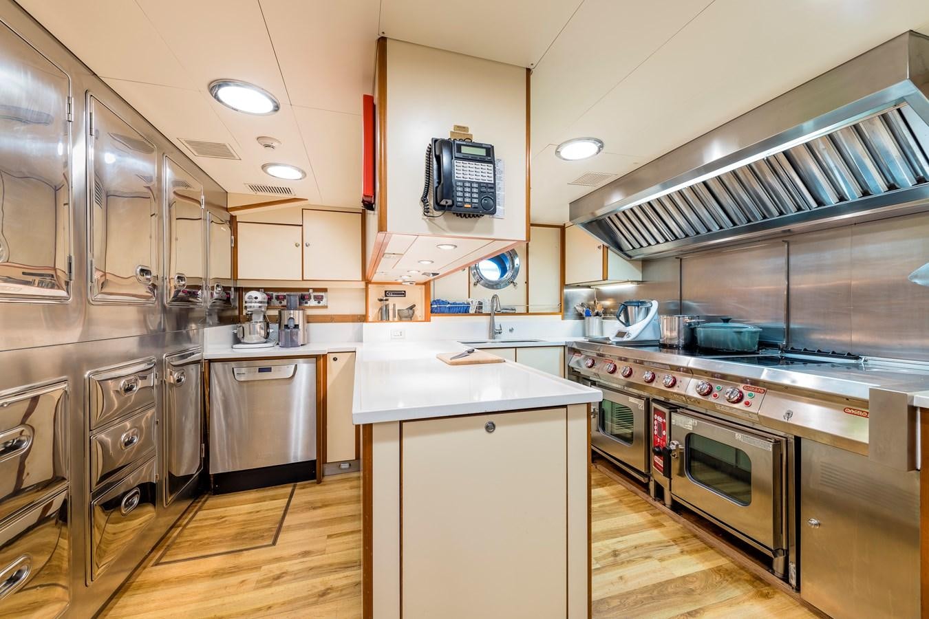 a kitchen with stainless steel appliances aboard ZENJI Yacht for Sale