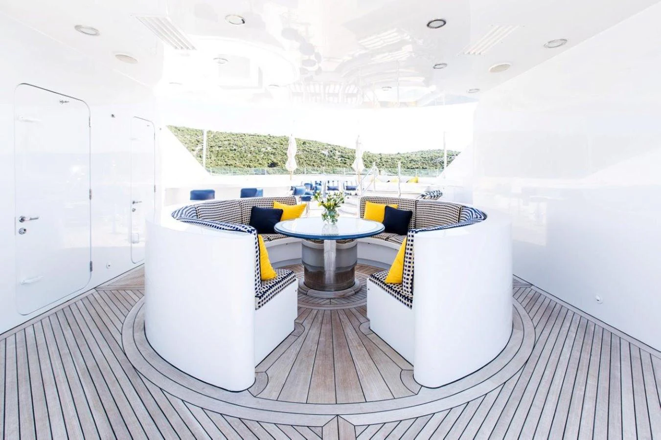 a room with a table and couch aboard MUSTIQUE Yacht for Charter
