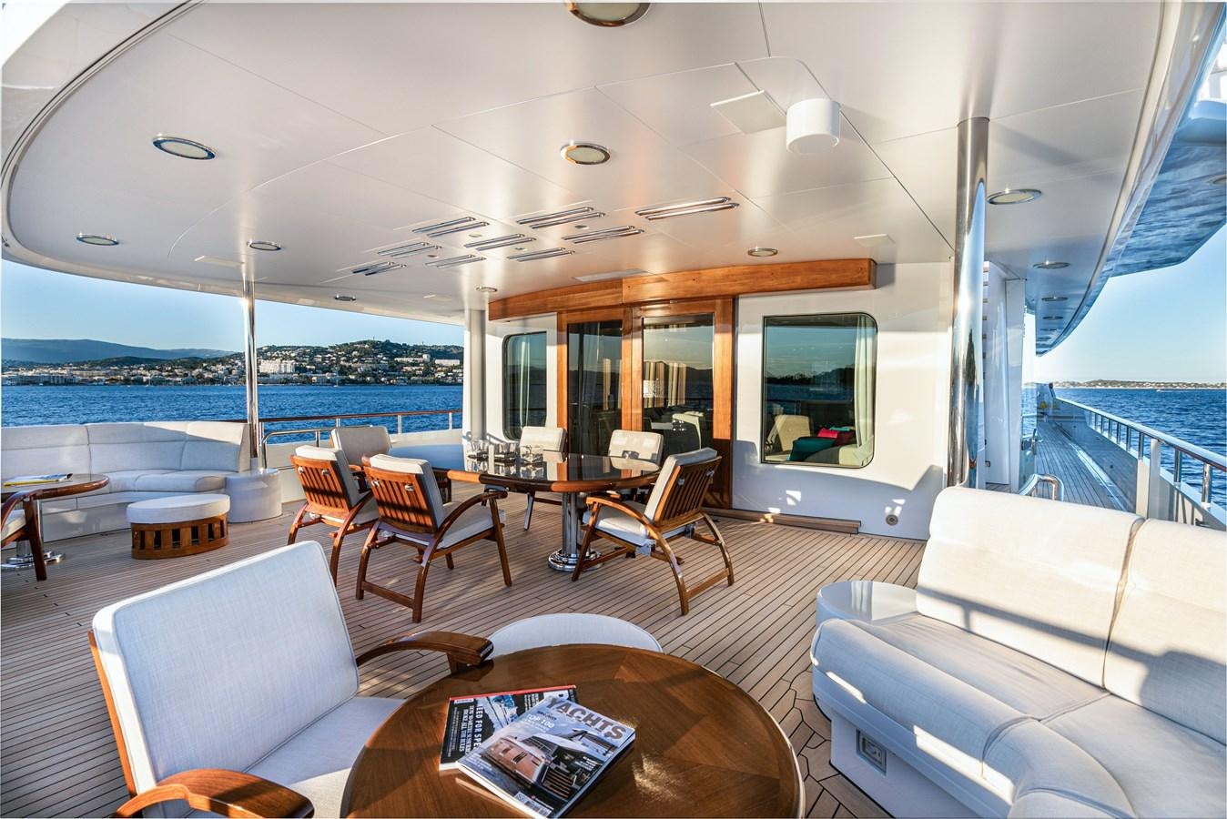 a living room with a large window overlooking the ocean aboard SEA HUNTRESS Yacht for Sale