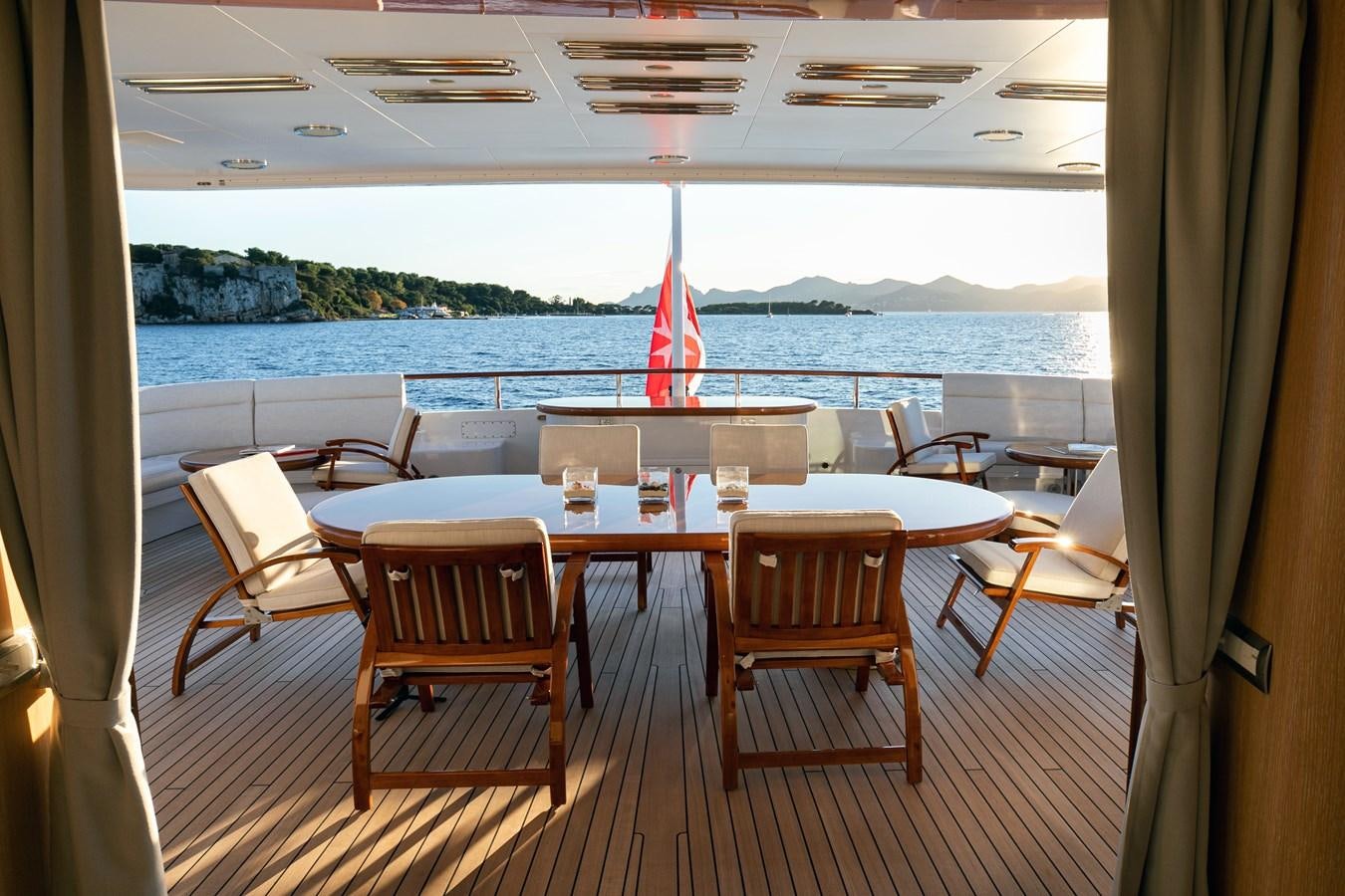 a table with chairs around it aboard SEA HUNTRESS Yacht for Sale