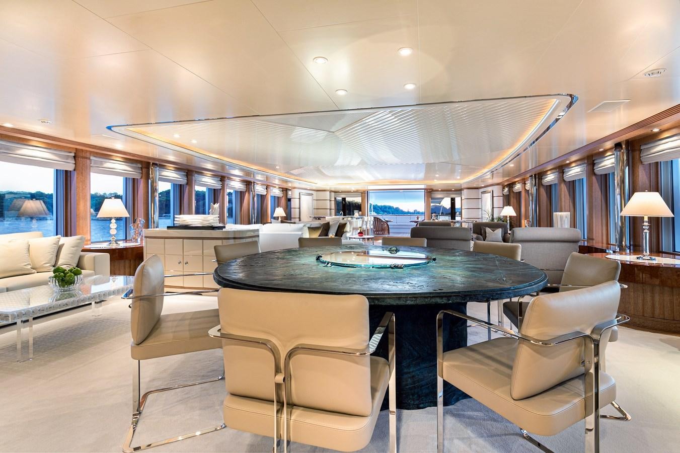 a large room with a table and chairs aboard SEA HUNTRESS Yacht for Sale