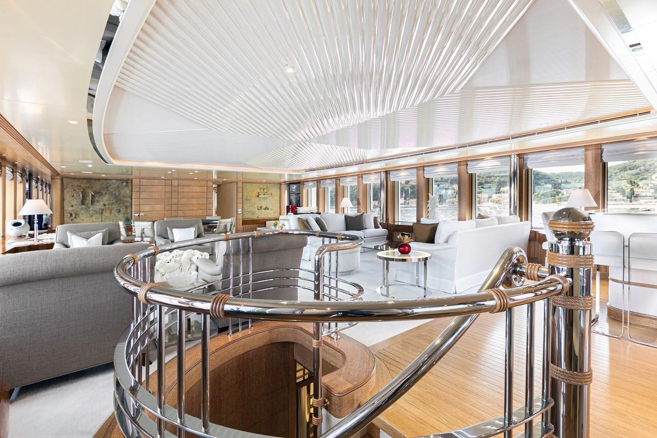 a large living room with a large piano aboard SEA HUNTRESS Yacht for Sale
