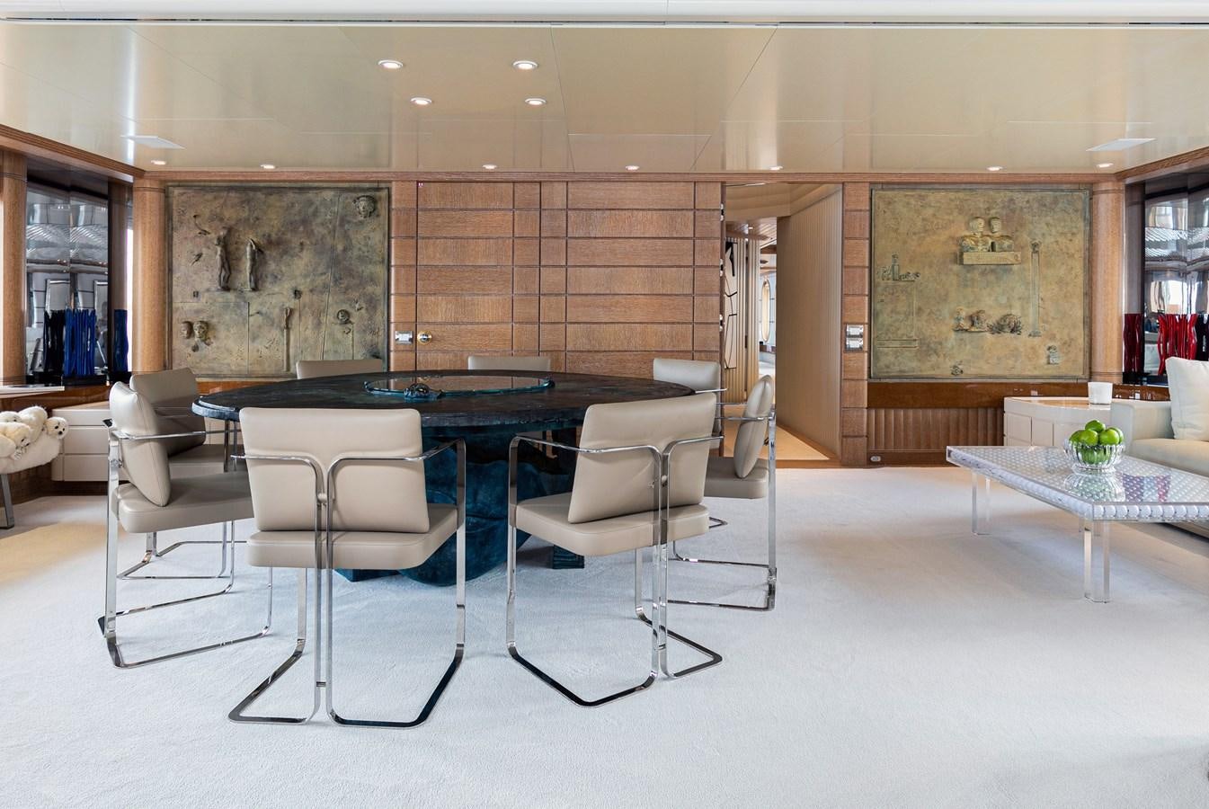 a room with a table chairs and a bar aboard SEA HUNTRESS Yacht for Sale