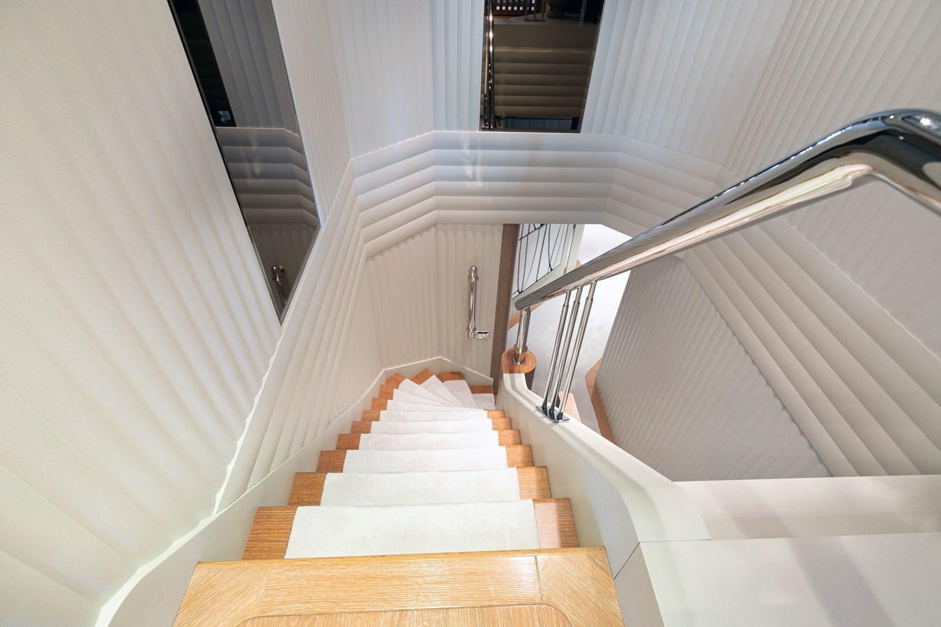 a white staircase with a railing aboard SEA HUNTRESS Yacht for Sale