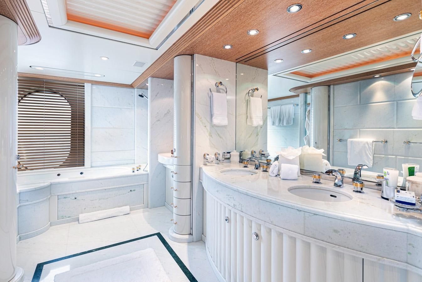 a bathroom with a sink and a mirror aboard SEA HUNTRESS Yacht for Sale