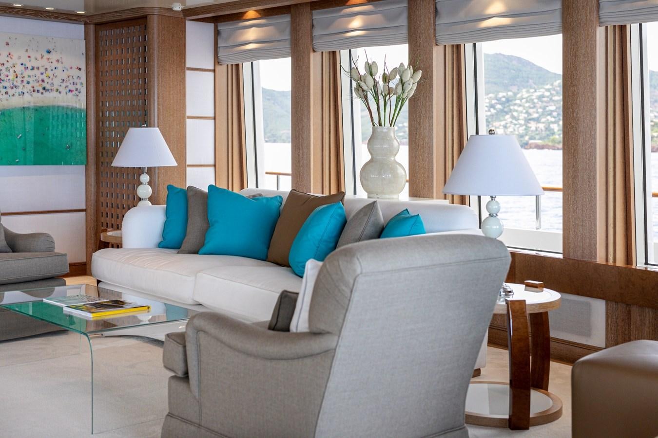 a living room with a couch and a lamp aboard SEA HUNTRESS Yacht for Sale