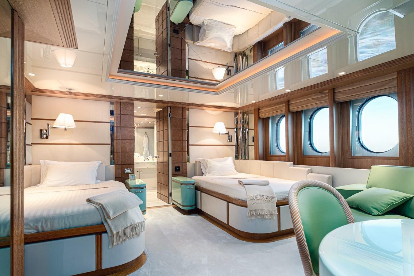 a room with a bed and a chair aboard SEA HUNTRESS Yacht for Sale