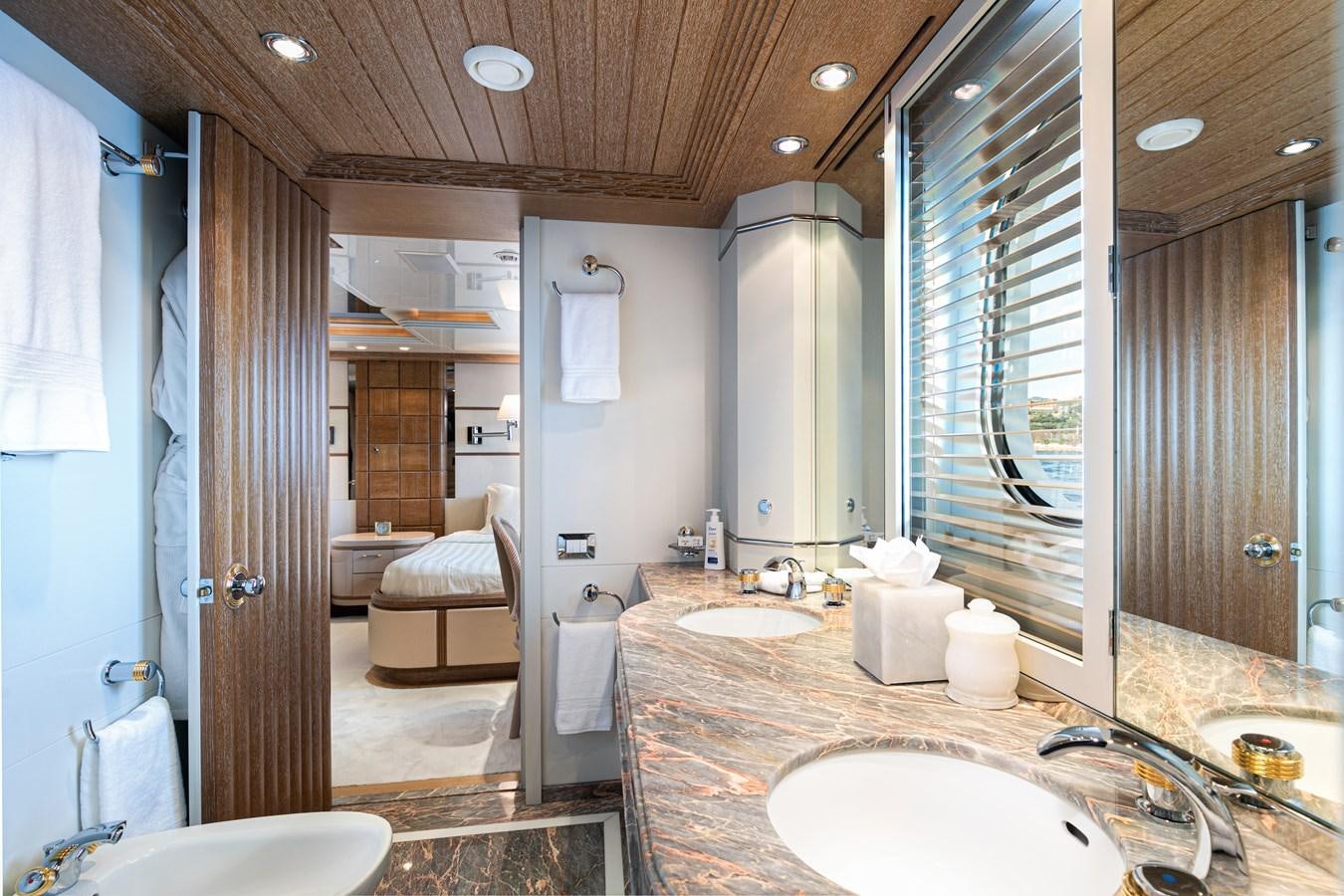 a bathroom with a sink and a mirror aboard SEA HUNTRESS Yacht for Sale