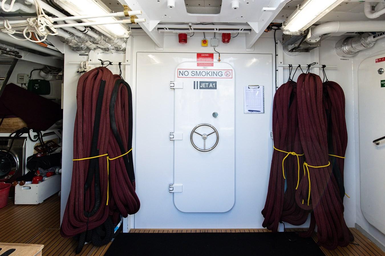 a closet with clothes on the wall aboard SEA HUNTRESS Yacht for Sale