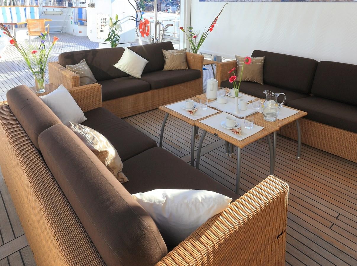 a living room with couches and a coffee table aboard SANSSOUCI STAR Yacht for Charter
