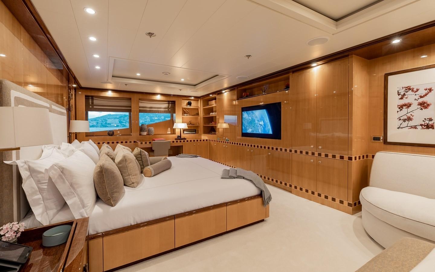 a room with a bed and a tv aboard LIND Yacht for Charter