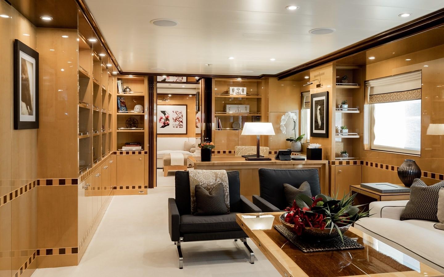 a living room with a bookcase aboard LIND Yacht for Charter