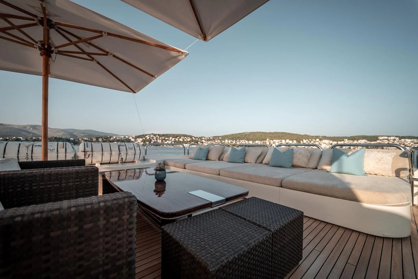 a patio with a couch and a table with a large umbrella aboard MERCURY Yacht for Sale