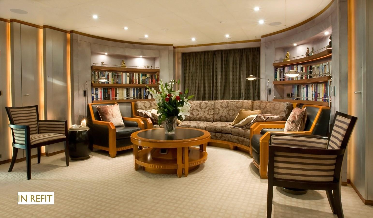a living room with a couch and a coffee table aboard QUEEN AIDA Yacht for Sale