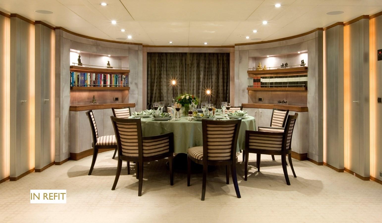 a room with a table chairs and a bookcase aboard QUEEN AIDA Yacht for Sale