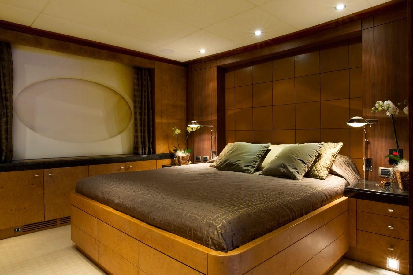 a bed with a large mirror above it aboard QUEEN AIDA Yacht for Sale