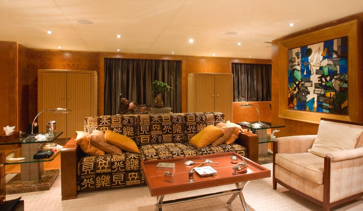 a living room with a couch and a coffee table aboard QUEEN AIDA Yacht for Sale
