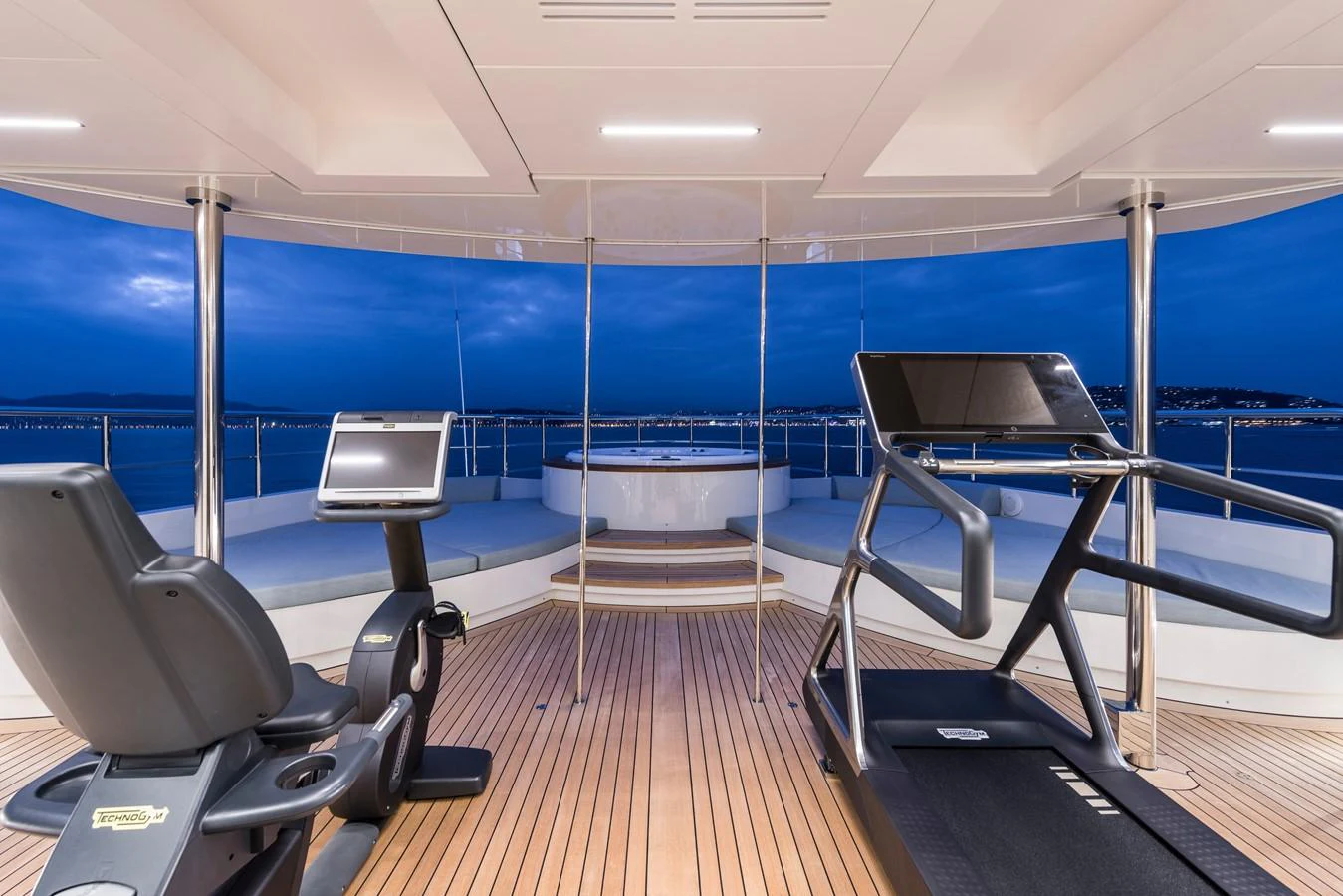 a room with a large window and a table with chairs aboard I NOVA Yacht for Sale