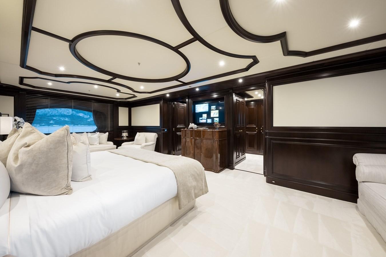 a room with a bed and a large mirror aboard ELENI Yacht for Sale