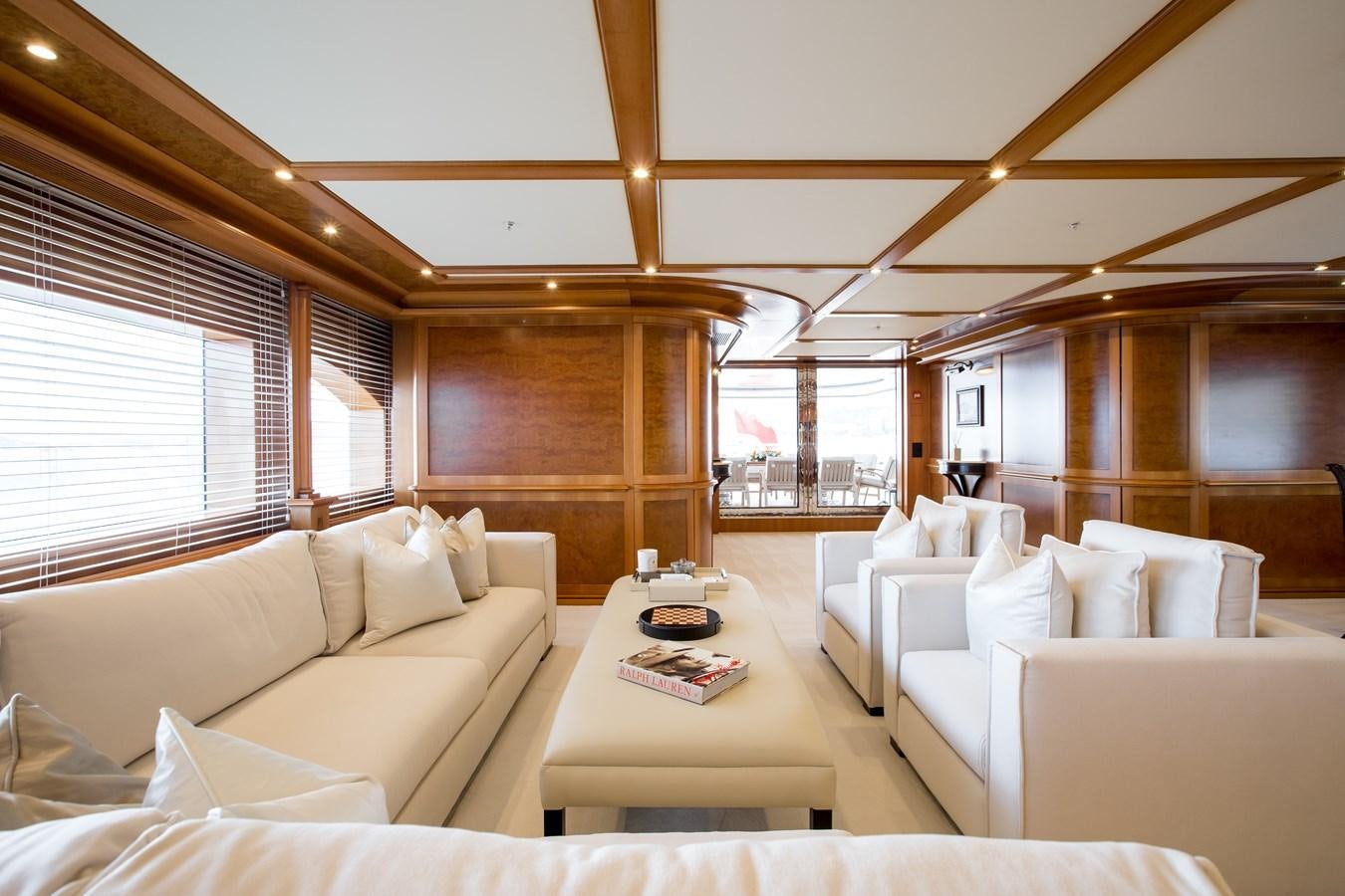 a living room with white couches aboard ELENI Yacht for Sale