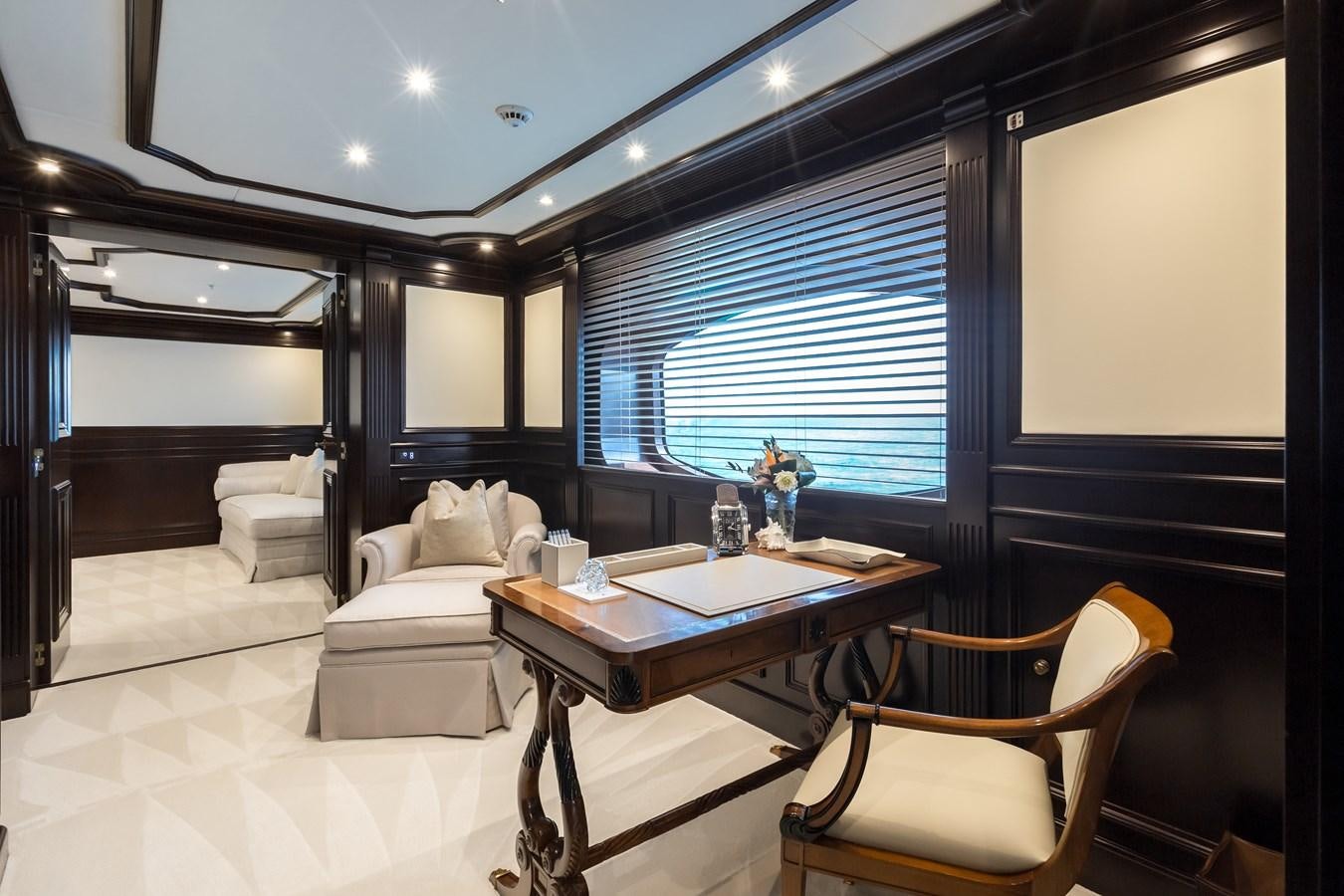 a room with a table chairs and a window aboard ELENI Yacht for Sale
