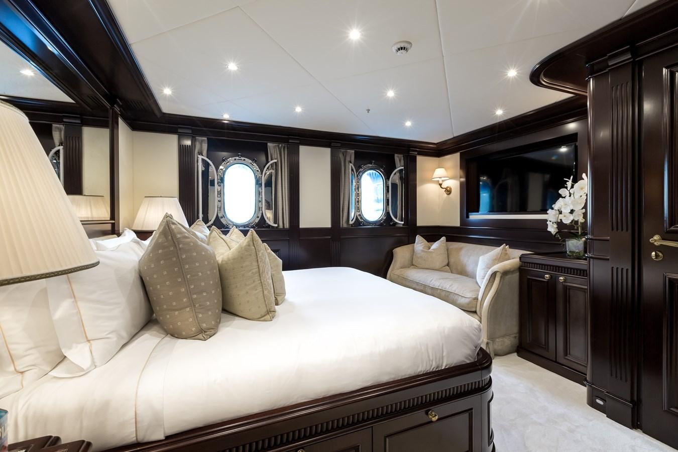 a room with a bed and a mirror aboard ELENI Yacht for Sale