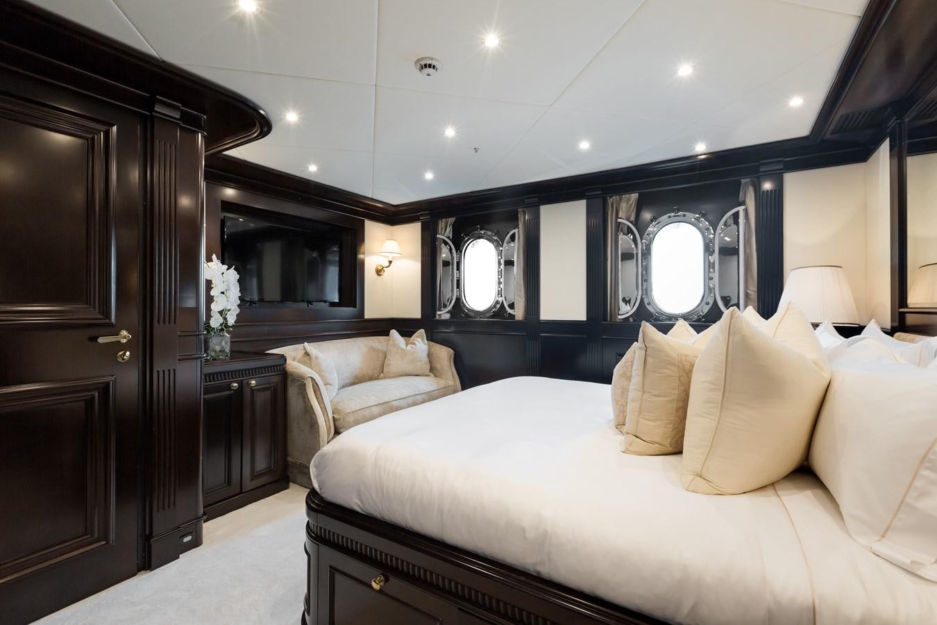 a room with a bed and a mirror aboard ELENI Yacht for Sale