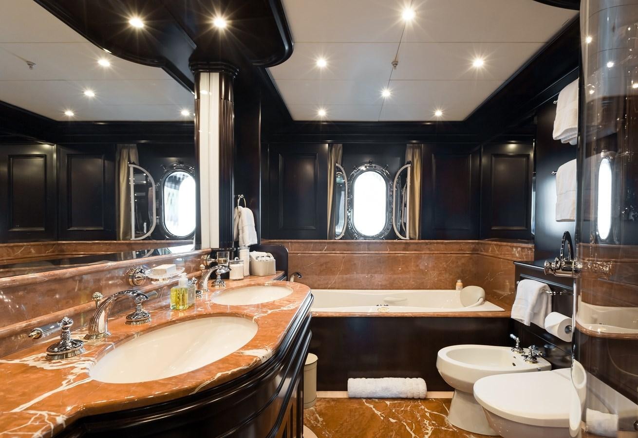 a bathroom with a large mirror aboard ELENI Yacht for Sale
