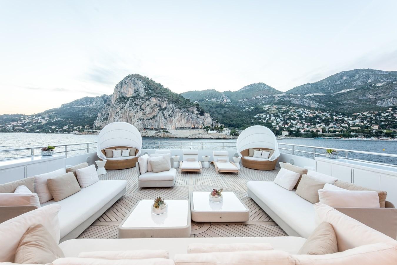 a room with a large white lounge chair and a large body of water aboard ELENI Yacht for Sale