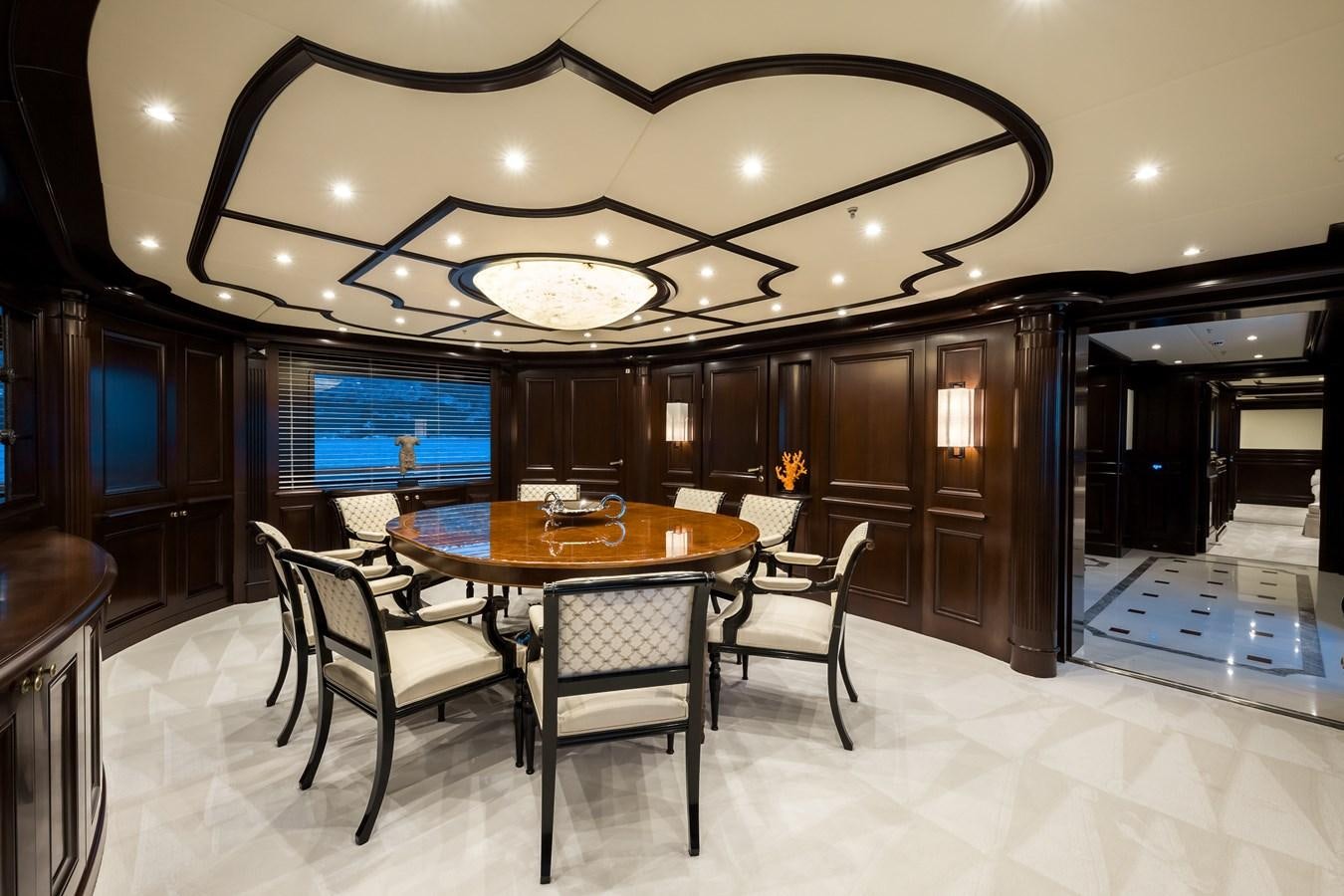 a dining room with a table and chairs aboard ELENI Yacht for Sale