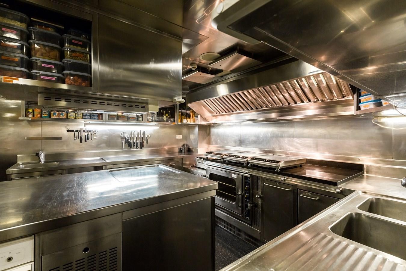 a kitchen with stainless steel appliances aboard ELENI Yacht for Sale