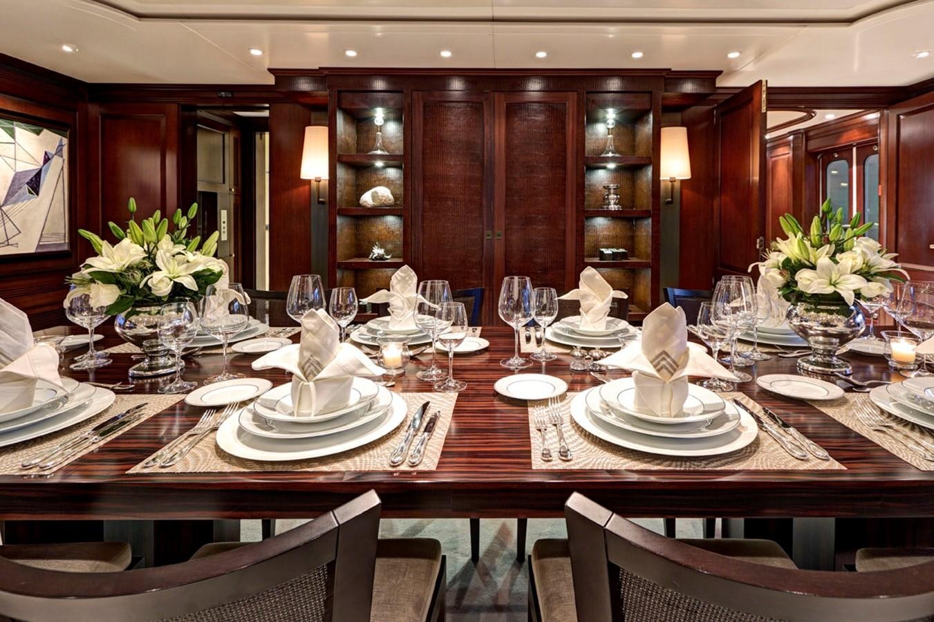 a table with plates and glasses aboard AZTECA Yacht for Sale
