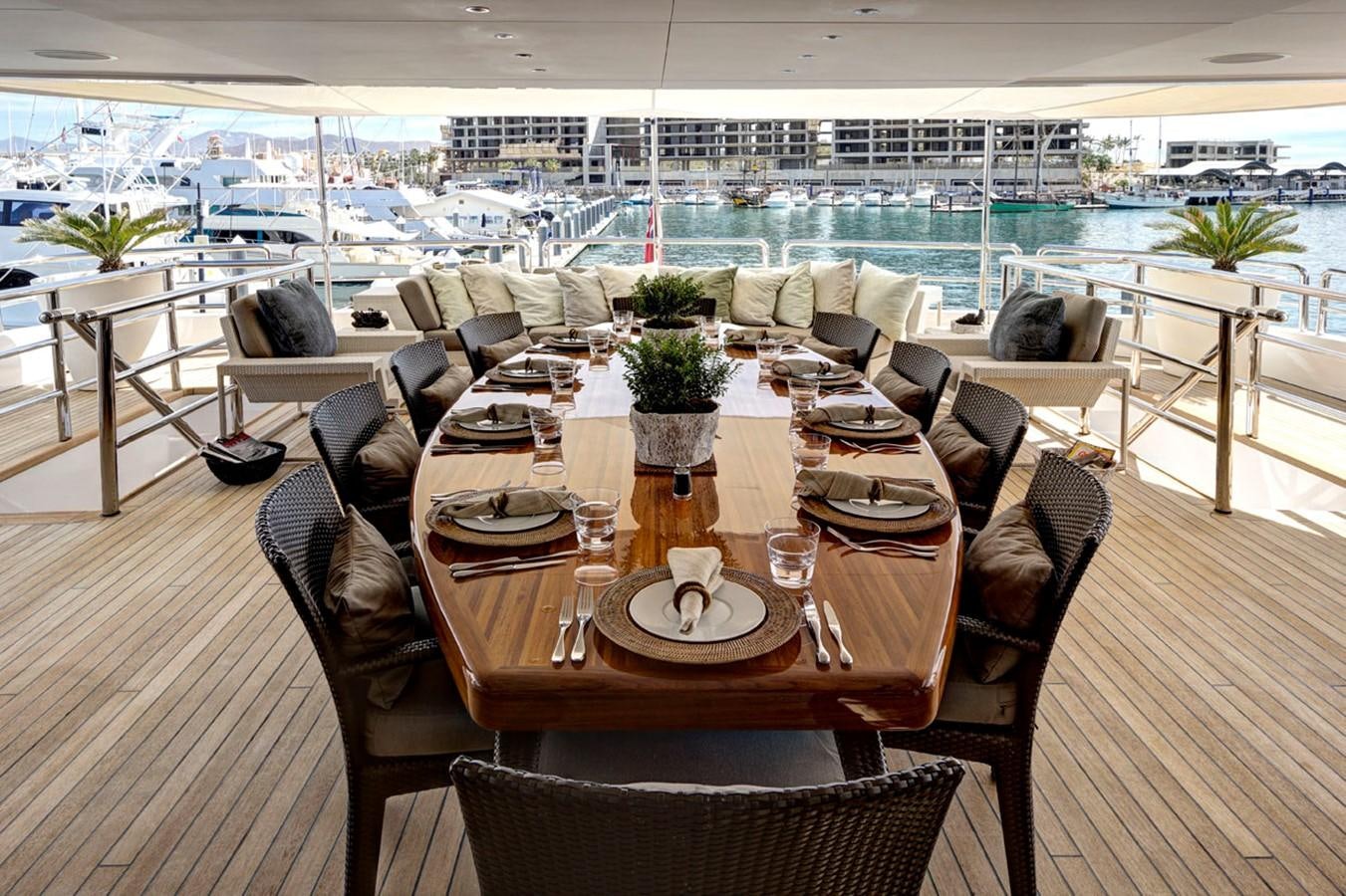 a dining room with a view of the water aboard AZTECA Yacht for Sale