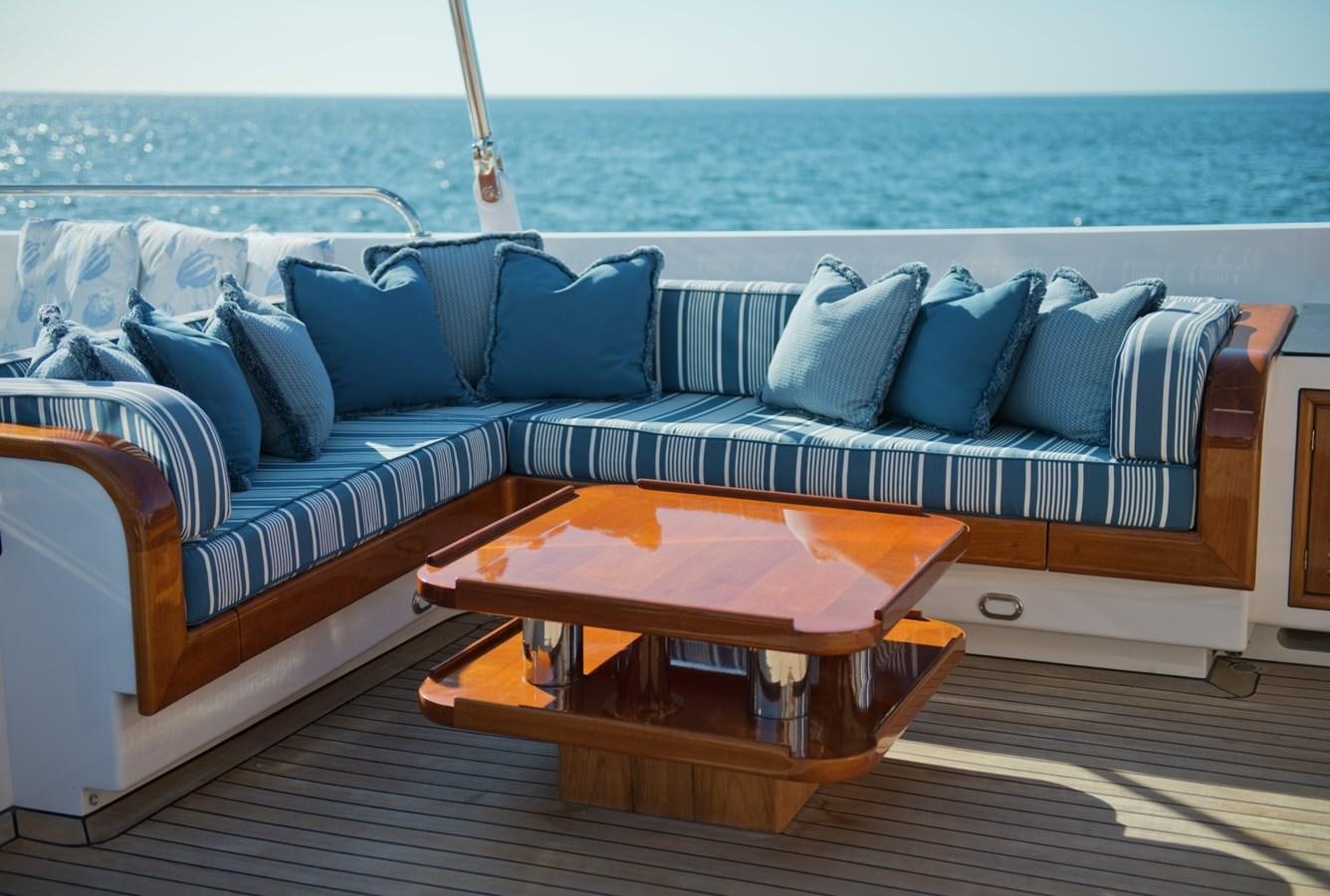 a couch with a coffee table on it aboard MORNING GLORY Yacht for Sale